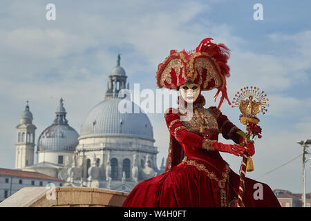 Venetian Masks  in red costumes in Venice Italy. Stock Photo