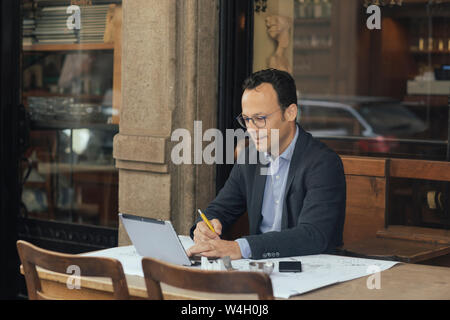 Businessman at work in a coffee shop Stock Photo