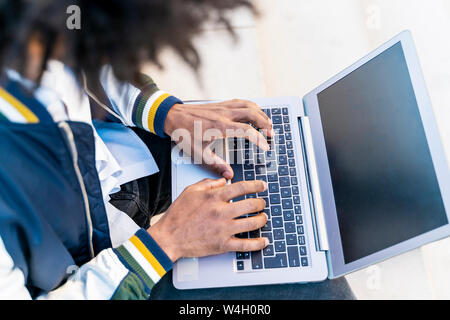 Close-up of businessman working on laptop outdoors Stock Photo