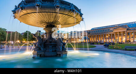 Palace square with fountain in front of Koenigsbau at dusk, Stuttgart, Germany Stock Photo