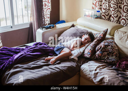 Little boy sleeping on bed couch in the morning Stock Photo