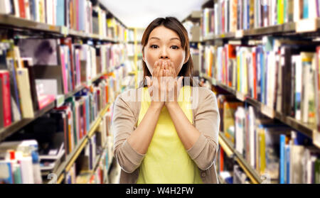 scared asian woman at library Stock Photo