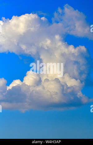Puffy white clouds against a blue sky in rural Alberta Canada Stock Photo