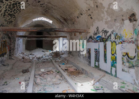 Derelict building on Santorini, grafitti, broken timbers and windows Stock Photo