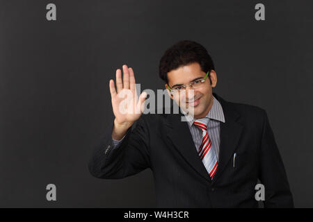 Indian businessman waving hand Stock Photo