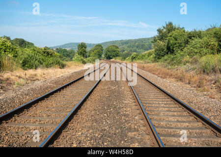 Railway tracks passing through countryside landscape in the North Downs, Surrey Hills AONB, UK Stock Photo