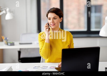 ui designer calling on smartphone at office Stock Photo