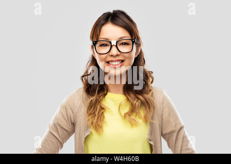 happy asian woman in glasses or student Stock Photo