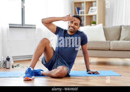 tired indian man after training at home Stock Photo