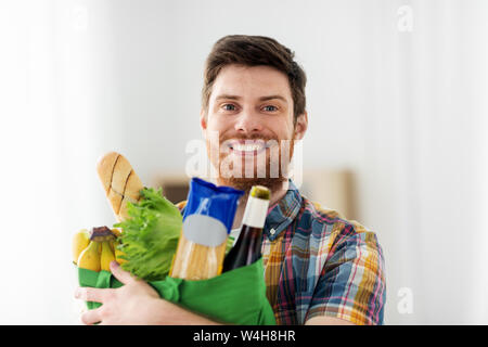 smiling young man with food in bag Stock Photo