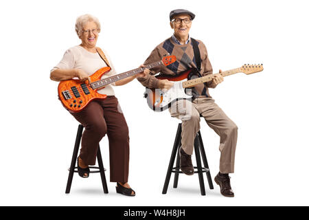 Full length portrait of a senior man and woman sitting and playing electric guitars isolated on white background Stock Photo