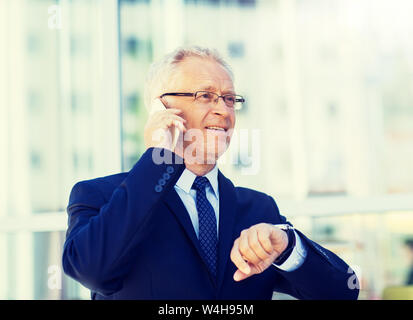 senior businessman calling on smartphone in city Stock Photo