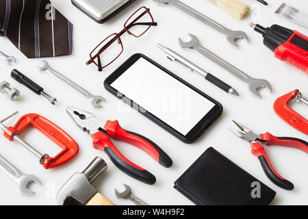 Flat lay mock up Smart Phone With man's accressories and essential construction tools worker on white background. Mockup mobile phone for your adverti Stock Photo