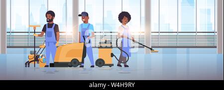 cleaners team in uniform working together cleaning service concept african american janitors using professional equipment modern hall interior Stock Vector