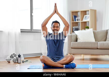 indian man meditating in lotus pose at home Stock Photo - Alamy
