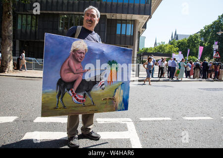 London, UK. 23 July, 2019. Political artist Kaya Mar displays his painting depicting Boris Johnson in front of campaigners for a People’s Vote protesting outside the Queen Elizabeth II Centre prior to the announcement inside the venue that Boris Johnson had been elected as leader of the Conservative Party and would replace Theresa May as Prime Minister. Credit: Mark Kerrison/Alamy Live News Stock Photo
