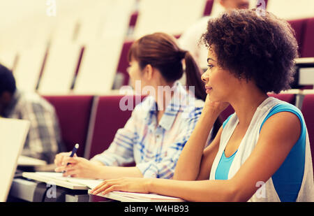 group of students talking in lecture hall Stock Photo