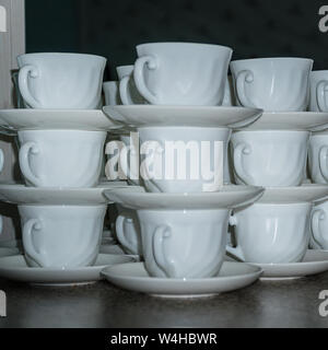 Coffee cups with saucers in stacks Stock Photo