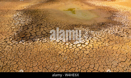 The concept of natural drought of the environment on Earth: dry soil, cracked soil with soil erosion Becomes red that is not agricultural Stock Photo
