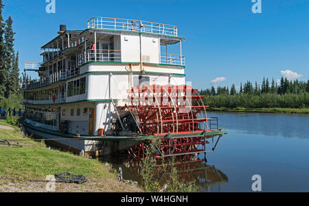 tourists boarding a sternwheel river boat to cruise the Chena River near Fairbanks in Alaska with the river and forest in the background Stock Photo