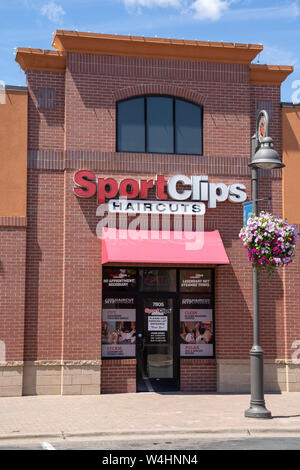 Maple Grove, Minnesota - July 21, 2019: Exterior of a SportClips Haircuts salon and barber shop. Portrait orientation Stock Photo