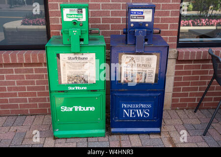 Maple Grove, Minnesota - July 21, 2019: Newspaper vending machine kiosks for the StarTribune and St Paul Pioneer Press, the two major daily papers in Stock Photo