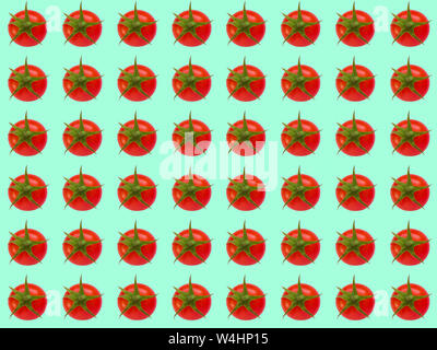 Red cherry tomato on a green background. Cheerful background and seamless pattern. Stock Photo