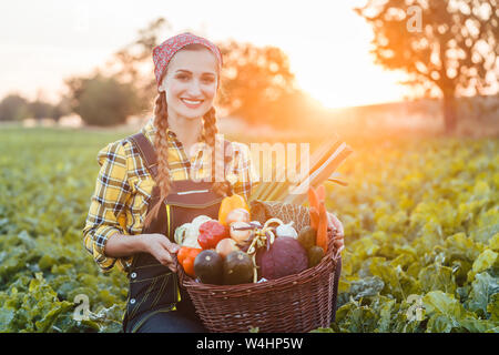 Farmer woman in the country going to market with vegetable basket Stock Photo