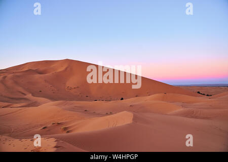 Beautiful pink sunset at big dunes in Sahara desert Morocco Africa Stock Photo