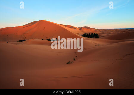Sun rising on the big sand dune in Sahara desert Merzouga Morocco Africa Stock Photo