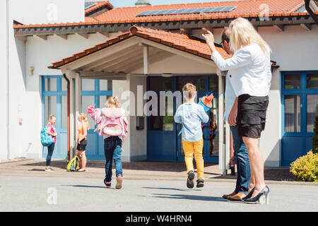 Mother wishing her daughter a happy day at school Stock Photo