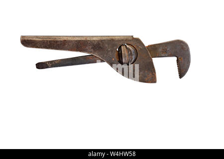 A very old, rusty pipe wrench is located horizontally and is isolated on a white background. Stock Photo