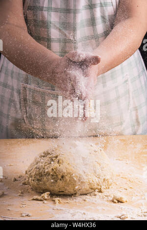 closeup of hands of a woman who juggles in the preparation of the dough for the preparation of homemade pasta Stock Photo