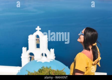 Profile View Of Woman Standing By Church  Against Sky, Thira, Santorini,  Greece Stock Photo