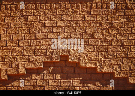 Traditional african historic hose facade made from straw bricks at direct sunlight in Morocco Stock Photo