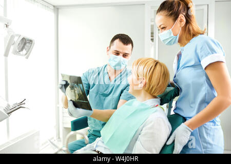 Dentist shows a x-ray image of a girl Stock Photo