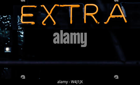 Extra word light signs .glowing neon bar alphabet on the dark background Stock Photo