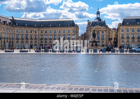Bordeaux, France - May 5, 2019: The Miroir d'eau or Miroir des Quais on the quay of the Garonne in front of the Place de la Bourse in Bordeaux