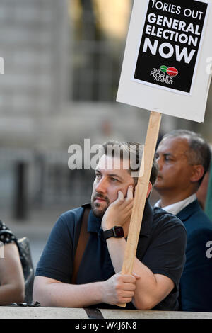 Anti Boris Johnson protester holds a placard during the rally.Protesters gathered outside Downing Street to protest against the announcement of Tory Boris Johnson as a new UK Prime Minister, who was elected only by less than 150,000 members of the Conservative party, a party that doesn’t hold a majority in Parliament. They demanding an immediate general election and launched plans to protest at the Conservative party national conference later this year. Stock Photo