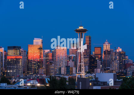 The Seattle Skyline seen from Kerry Park with reflections of the orange and pink sunset in the glass of the skyscrapers Stock Photo