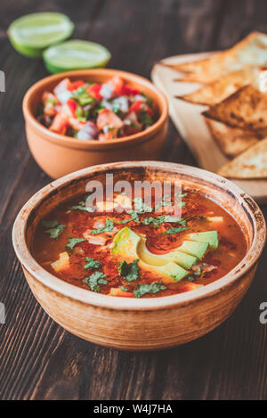 Bowl of spicy Mexican soup with grilled tortillas and salsa Stock Photo