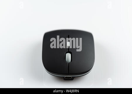 Black wireless computer mouse on a white background. Stock Photo