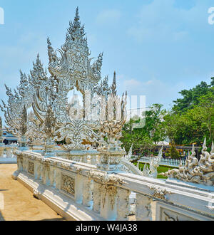 CHIANG RAI, THAILAND - MAY 9, 2019: The intricate plasterwork with mirror patterns decorates the White Temple (Wat Rong Khun), on May 9 in Chiang Rai Stock Photo