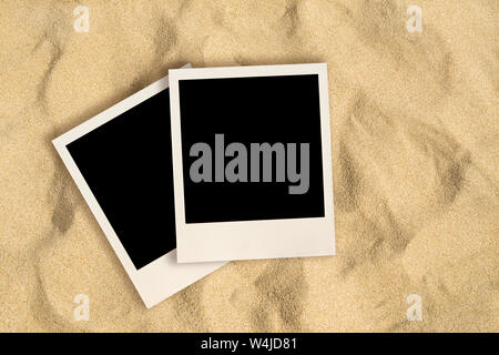 Blank instant images on sand background Stock Photo