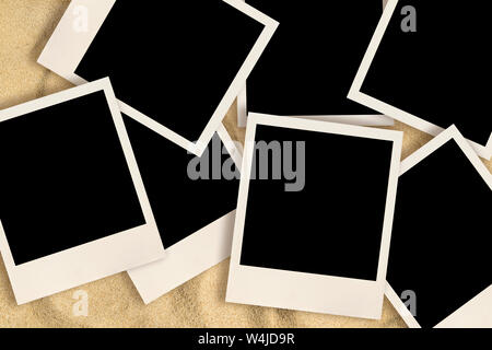 Blank instant images on sand background Stock Photo