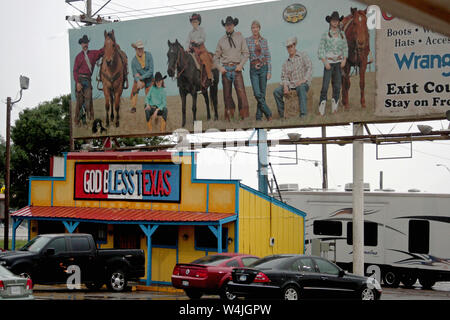 God Bless Texas sign and large billboard featuring cowboys in Amarillo, Texas, USA Stock Photo