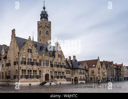 Diksmuide, Flanders, Belgium -  June 19, 2019: Grote Markt. Wider shot of Brown brick historic City Hall, or Stadhuis, building under light blue sky. Stock Photo