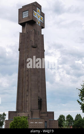 Diksmuide, Flanders, Belgium -  June 19, 2019: Closeup of IJzertoren, tallest peace monument of WW 1 against gray blue cloudscape. Dutch words saying Stock Photo