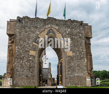 Diksmuide, Flanders, Belgium -  June 19, 2019: Black on White Crypt memorial, remnants of dynamited tower, and Pax gate in front with sculptures under Stock Photo