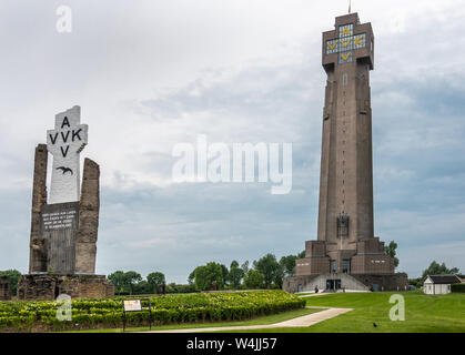 Diksmuide, Flanders, Belgium -  June 19, 2019: Black on White Crypt memorial, remnants of dynamited tower, and new IJzertoren, tallest peace monument Stock Photo